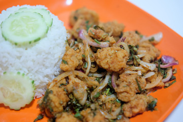 Fried chicken in spicy condiment salad with rice