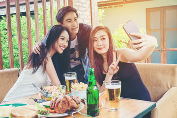 Group of friends are taking selfie and eating food are happy enjoying in home