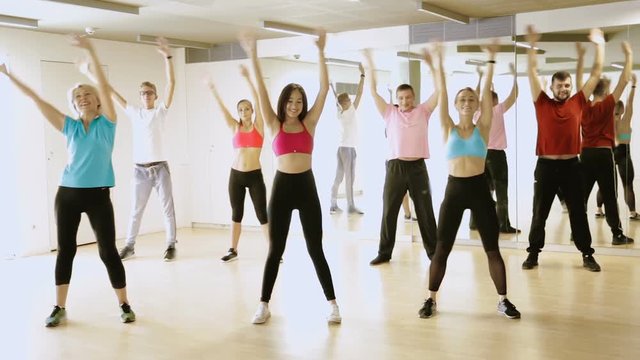 Portrait of fitness people dancing aerobics in dance class
