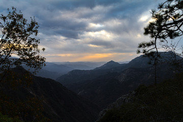 Sunset view bookended by streets of Sequoia and Kings Canyon National Park after a storm.
