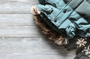 Women's warm winter clothing and accessories  - jacket and gloves. Wish list or shopping overview concept.  Fashion concept. View from above. Flat lay