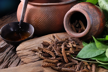 East Indian screw tree and Tea ,Thai herb for health on wooden background.