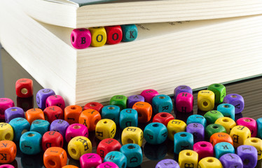 Word book written on a colorful wooden block in a book.