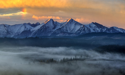 Obraz na płótnie Canvas mountain panorama (Tatra Mountains) with multicolored, dramatic sky