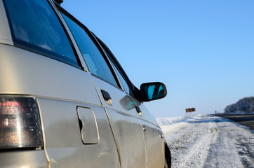 Fototapeta na wymiar Car on a roadside on winter