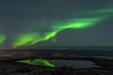 Aurora in the sky and the reflection in the water.