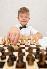 Happy boy playing a game of chess