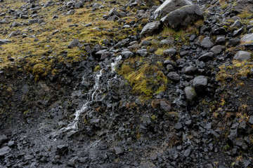 Micro waterfall crossing the road