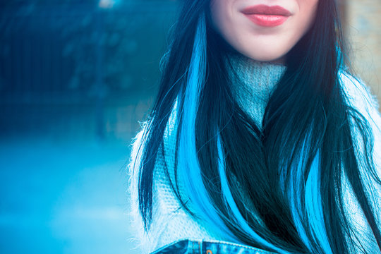 Girl with blue locks in her hair. Fashionable hair among young people or teenagers