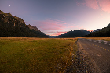 Dawn on the road to Milford Sound. Sunrise on a highway in New Zealand.