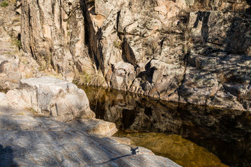 Water from the Perales River, in the mountains of Madrid, eroding the granite rocks