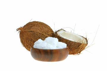 unrefined coconut oil. coconut in a cut and white natural coconut oil in a brown wooden round cup isolated on a white background