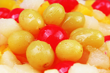 Fruit salad texture. Fruits as background pattern. Exotic Fruits Fruit salad with cocktail cherry sour cherry mango pineapple grapes,pear,papaya in syrup. Sweet,