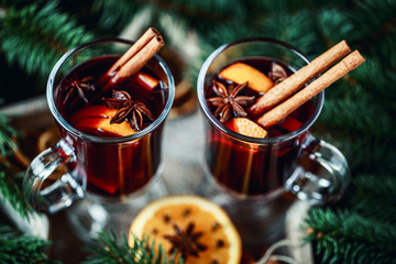 Christmas hot mulled wine in a glass with spices and citrus fruit. Mulled wine with cinnamon, anise and orange