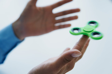 Man holds a spinner on white isolated background