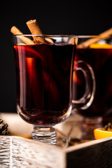 Christmas hot mulled wine in a glass with spices and citrus fruit. Mulled wine with cinnamon, anise and orange