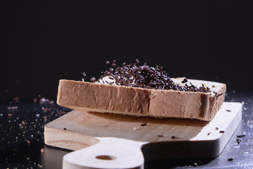 Splash chocolate sprinkle on a slice of plain bread.