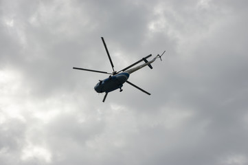 Fototapeta na wymiar The flying helicopter in the sky
