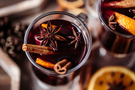 Christmas hot mulled wine in a glass with spices and citrus fruit. Mulled wine with cinnamon, anise and orange