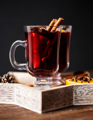 Christmas hot mulled wine in a glass with spices and citrus fruit. Mulled wine with cinnamon, anise and orange