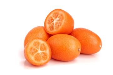 Cumquat or kumquat with half isolated on white background close up