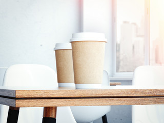 Table in the restaurant with a two cups of coffee. 3d rendering