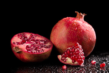 Ripe pomegranate fruits on a black background