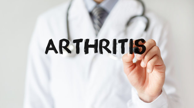 Doctor writing word Arthritis with marker, Medical concept