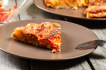 Tortilla de patatas. Spanish omelette with sausage chorizo, potatoes, paprika and egg, accompanied by olive oil