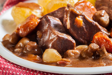 Beef Bourguignon stew served with baked potatoes