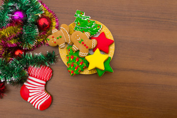 Plate with tasty Christmas cookies on wooden table