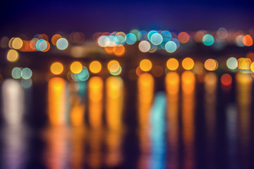 abstract blue circular bokeh background, city lights with reflection in water