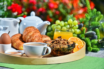 Breakfast served with coffee, juice, croissants and fruits