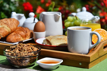 Obraz na płótnie Canvas Breakfast served with coffee, juice, croissants and fruits