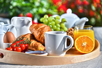 Breakfast served with coffee, juice, croissants and fruits