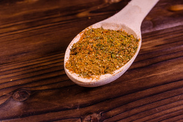 Mix of different seasonings in wooden spoon