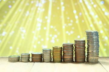 Coin stack with blur light dreamy bokeh background. Business, finance and saving concept.
