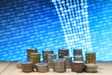 Digital economy. Coin stack increasing chart shape with Blue light and binary digital numbers background. Business, finance and saving concept.