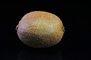 Kiiwi on isolated black mirror mirrored reflective background. Fruit.