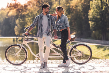 Couple with a tandem bicycle
