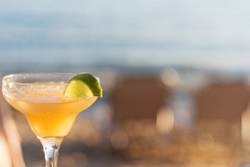 Refreshing Classic Margarita Cocktail With Lime And Salt By The Beach At Sunset On Blurred Background