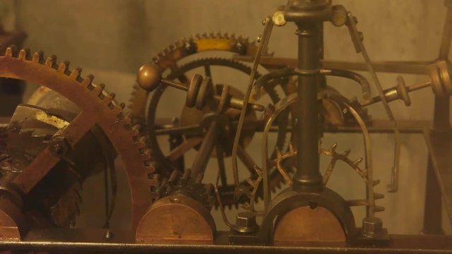 Old clock mechanism close up. Pendulum and cogs. How timepieces work.