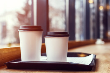 two glasses of coffee on a tray in a cafe