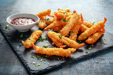 Fried Shrimps tempura with sweet chili sauce on black board stone