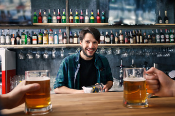 The bartender is working behind the bar