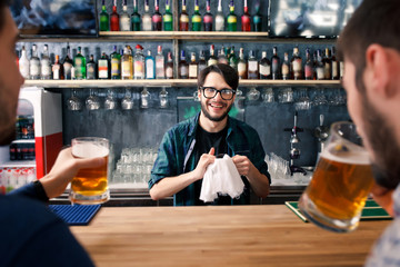 The bartender is working behind the bar
