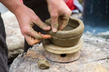 Creating a jar or vase of white clay close-up.