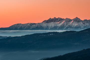 Obraz premium panorama over misty Gorce to snowy Tatra mountains in the morning, Poland landscape
