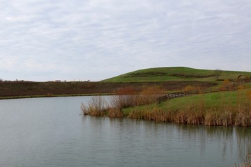 A view of the lake and the hill landscape in the background.