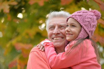 grandfather and granddaughter in park